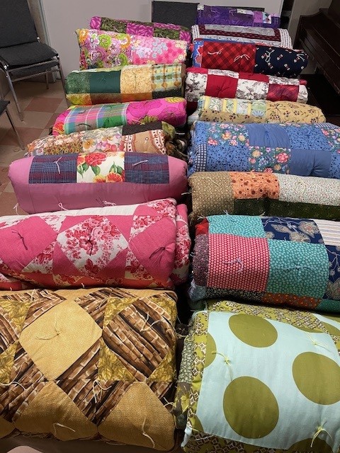 quilts rolled up in two rows